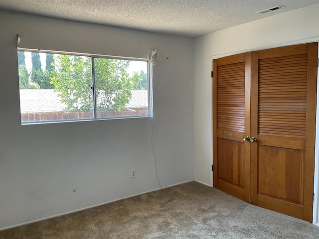 1110 E Alvarado St, Fallbrook, CA 92028 - unfurnished bedroom featuring carpet floors, a closet, and a textured ceiling