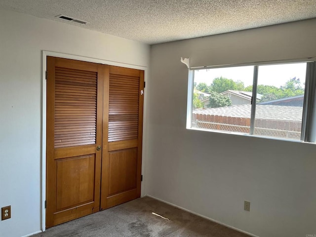 1110 E Alvarado St, Fallbrook, CA 92028 - unfurnished bedroom with carpet, a closet, and a textured ceiling