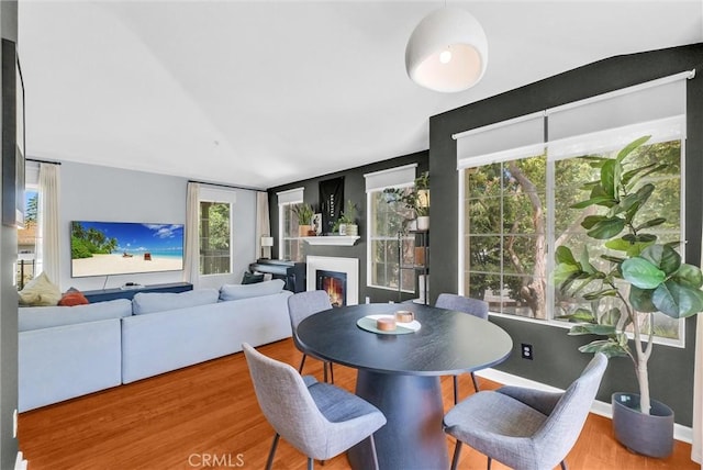 118 Gallery Way, Tustin, CA 92782 - dining room with a glass covered fireplace, wood finished floors, and plenty of natural light