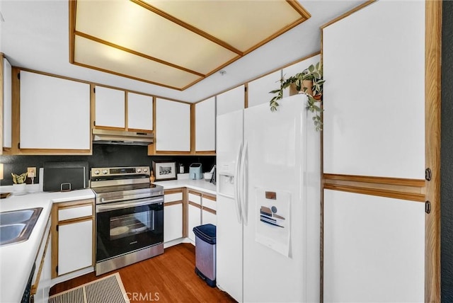 118 Gallery Way, Tustin, CA 92782 - kitchen featuring white refrigerator with ice dispenser, stainless steel range with electric stovetop, under cabinet range hood, light countertops, and white cabinetry