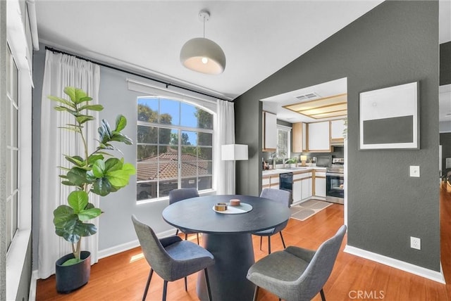 118 Gallery Way, Tustin, CA 92782 - dining space with vaulted ceiling, light wood finished floors, and healthy amount of natural light