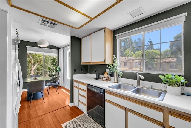 118 Gallery Way, Tustin, CA 92782 - kitchen with dishwasher, freestanding refrigerator, light wood-style flooring, light countertops, and white cabinetry