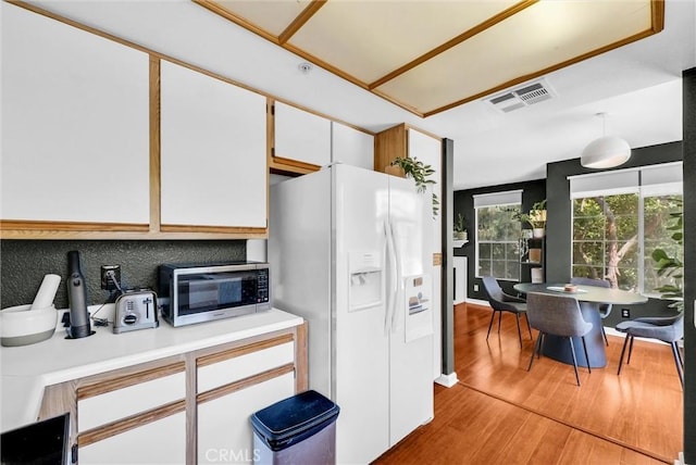 118 Gallery Way, Tustin, CA 92782 - kitchen with white fridge with ice dispenser, light wood-style floors, light countertops, white cabinetry, and stainless steel microwave