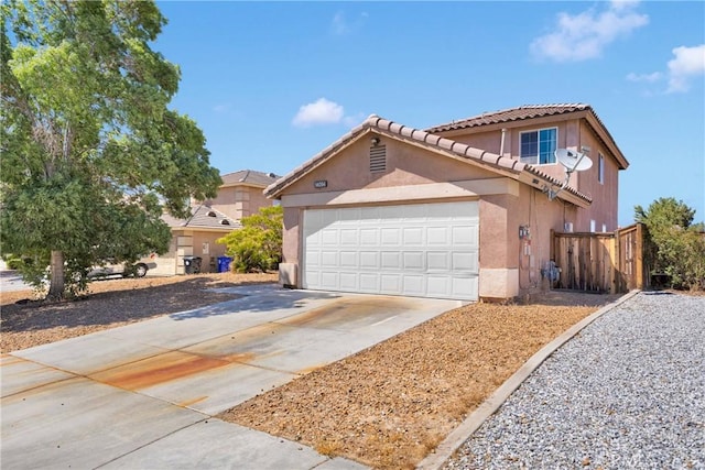 14094 Gray Ln, Victorville, CA 92394 - view of front of property featuring stucco siding, concrete driveway, a tile roof, and an attached garage