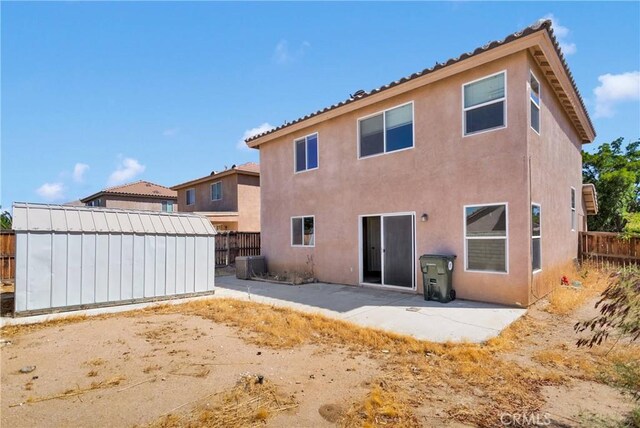14094 Gray Ln, Victorville, CA 92394 - back of house featuring stucco siding, a fenced backyard, and a patio