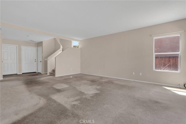 14094 Gray Ln, Victorville, CA 92394 - unfurnished living room with stairs, carpet, and plenty of natural light