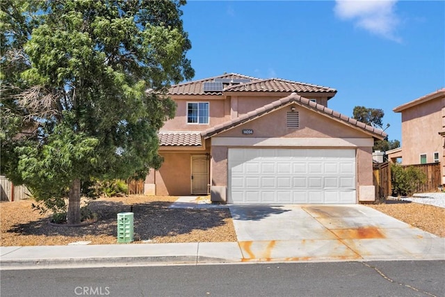 14094 Gray Ln, Victorville, CA 92394 - view of front of property with driveway, stucco siding, solar panels, a tile roof, and an attached garage