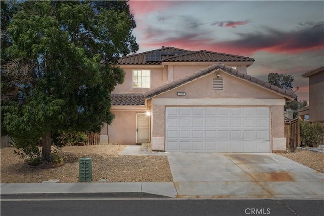 14094 Gray Ln, Victorville, CA 92394 - view of front of home featuring driveway, solar panels, stucco siding, and a tiled roof