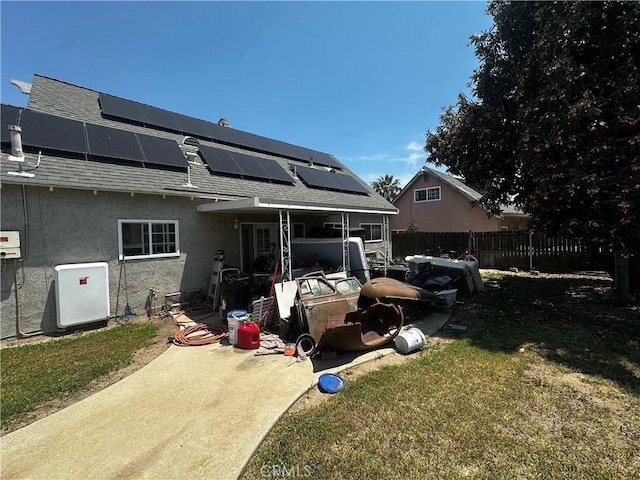 1374 N Primrose Ave, Rialto, CA 92376 - back of property with a shingled roof, stucco siding, and solar panels