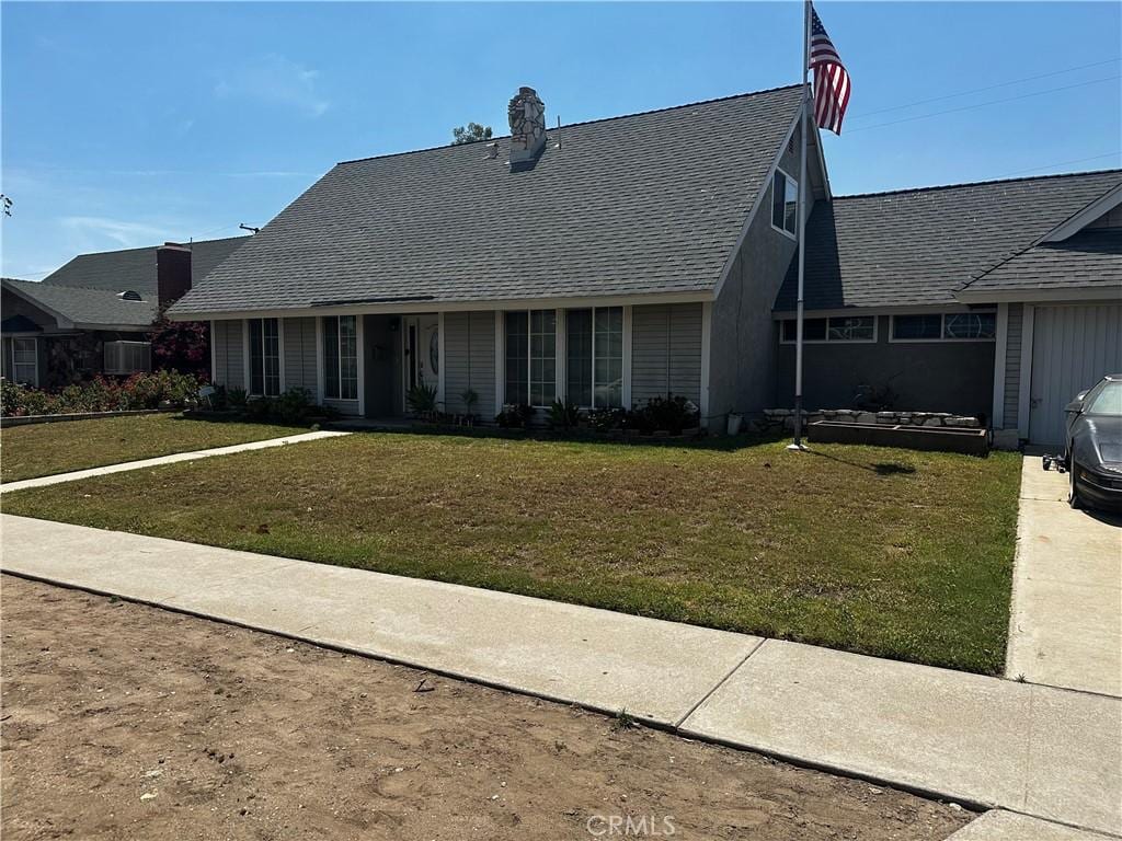 1374 N Primrose Ave, Rialto, CA 92376 - view of front of home featuring a front lawn and roof with shingles