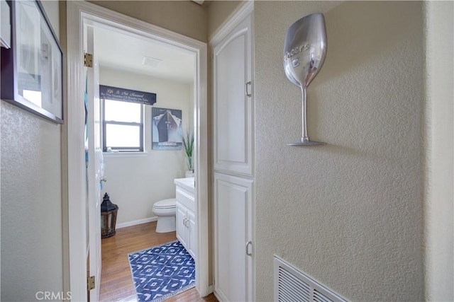 375 N 6th St, Grover Beach, CA 93433 - bathroom featuring wood finished floors, vanity, and a textured wall