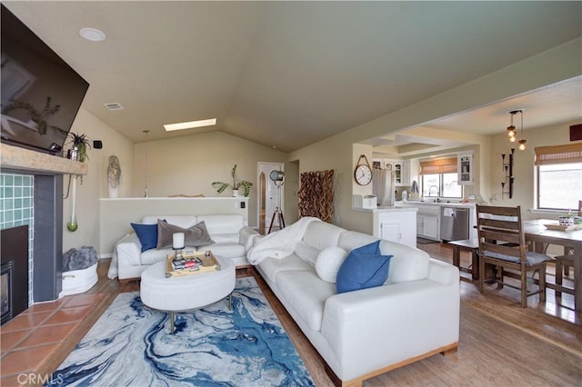 375 N 6th St, Grover Beach, CA 93433 - living room featuring lofted ceiling, a tile fireplace, and wood finished floors