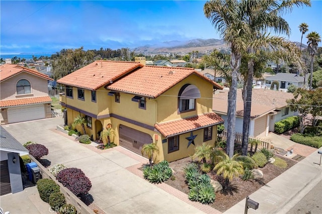 375 N 6th St, Grover Beach, CA 93433 - view of front facade featuring a garage, a tiled roof, stucco siding, and driveway