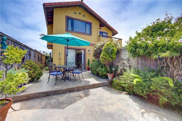 375 N 6th St, Grover Beach, CA 93433 - back of house featuring stucco siding, a patio area, and a fenced backyard