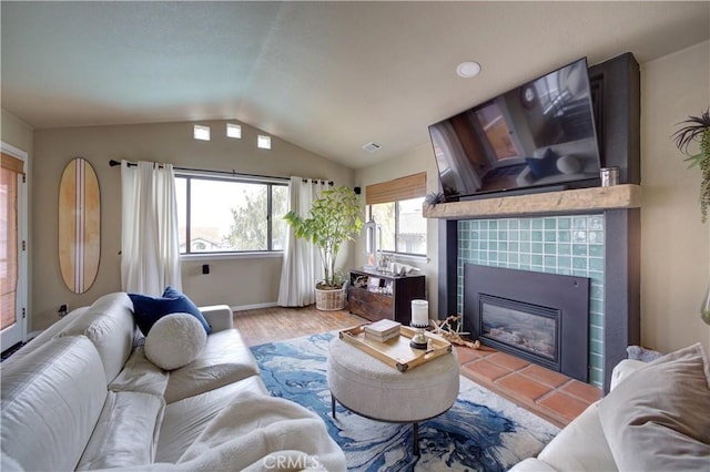 375 N 6th St, Grover Beach, CA 93433 - living room featuring lofted ceiling, a tile fireplace, and wood finished floors