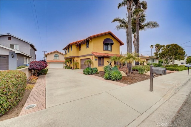 375 N 6th St, Grover Beach, CA 93433 - mediterranean / spanish-style home featuring a tile roof, driveway, stucco siding, and an attached garage