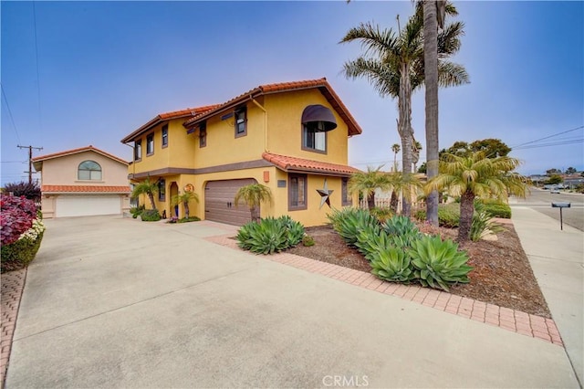 375 N 6th St, Grover Beach, CA 93433 - mediterranean / spanish-style home with an attached garage, concrete driveway, stucco siding, and a tiled roof