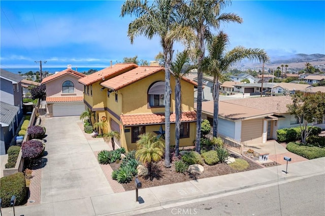 375 N 6th St, Grover Beach, CA 93433 - mediterranean / spanish home with a residential view, driveway, an attached garage, and stucco siding
