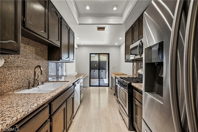 12355 Chandler Blvd Unit 101, Valley Village, CA 91607 - kitchen featuring stainless steel appliances, a tray ceiling, backsplash, light wood-style floors, and recessed lighting