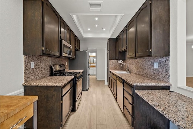 12355 Chandler Blvd Unit 101, Valley Village, CA 91607 - kitchen featuring appliances with stainless steel finishes, light wood finished floors, dark brown cabinets, and recessed lighting