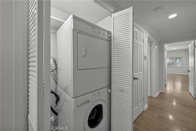 12355 Chandler Blvd Unit 101, Valley Village, CA 91607 - washroom featuring stacked washer and clothes dryer, crown molding, light wood finished floors, and recessed lighting