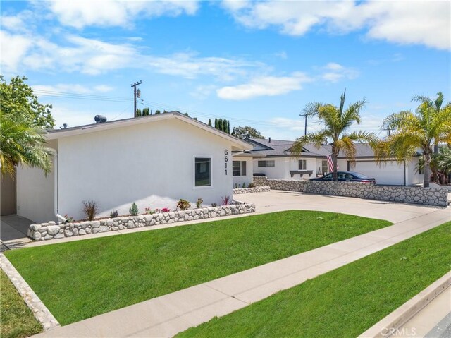 6611 Pickett Ave, Garden Grove, CA 92845 - ranch-style home featuring a front lawn, stucco siding, and driveway