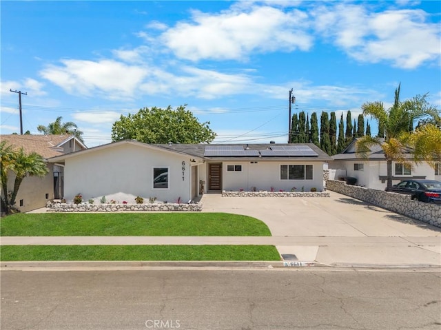 6611 Pickett Ave, Garden Grove, CA 92845 - ranch-style home with roof mounted solar panels, stucco siding, a front yard, and driveway