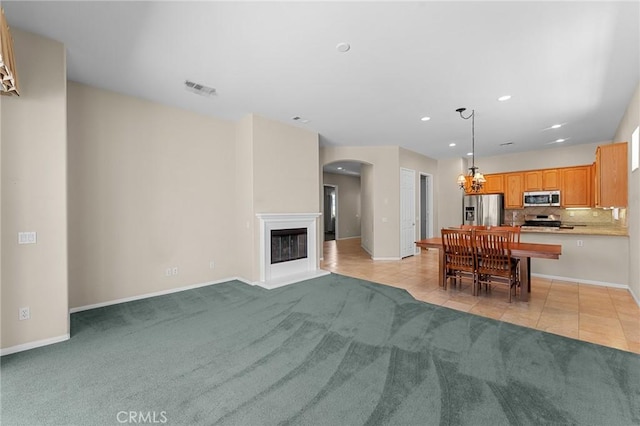 1790 N Forest Oaks Dr, Beaumont, CA 92223 - living area with arched walkways, light carpet, recessed lighting, a chandelier, and light tile patterned floors
