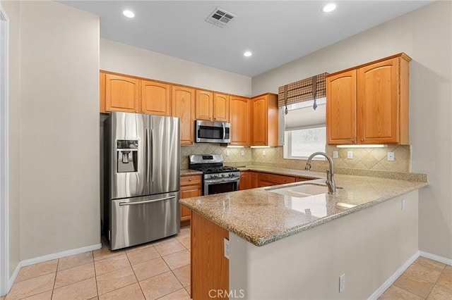 1790 N Forest Oaks Dr, Beaumont, CA 92223 - kitchen featuring appliances with stainless steel finishes, light stone counters, a peninsula, backsplash, and recessed lighting