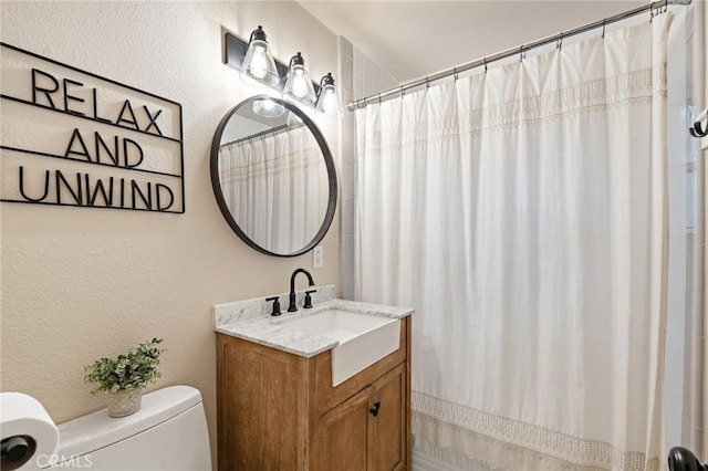716 N Tulare Way, Upland, CA 91786 - bathroom with vanity, a textured wall, and a shower with shower curtain