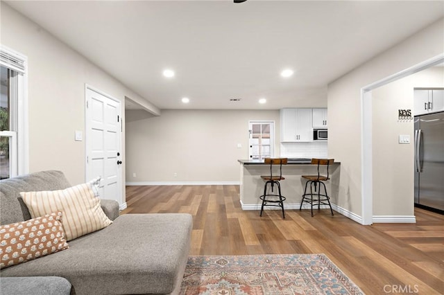 716 N Tulare Way, Upland, CA 91786 - living area featuring light wood finished floors and recessed lighting