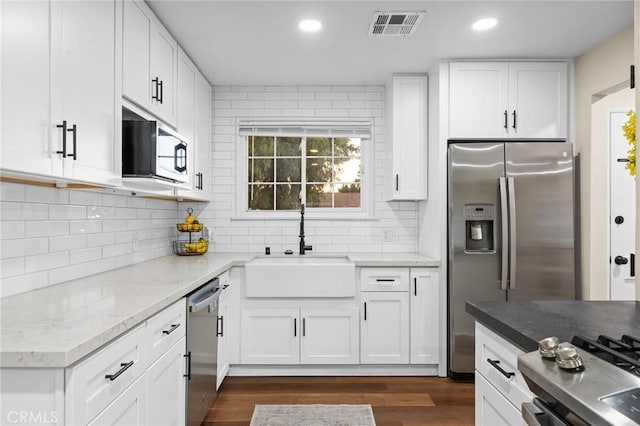716 N Tulare Way, Upland, CA 91786 - kitchen with stainless steel appliances, decorative backsplash, white cabinets, dark wood-style flooring, and recessed lighting