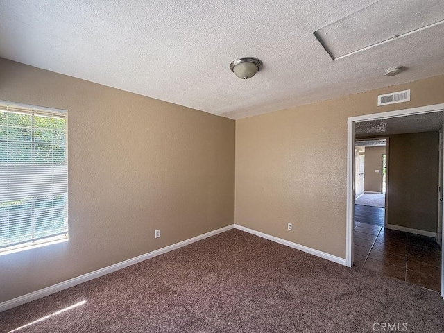 16702 Canoe Cv, Moreno Valley, CA 92551 - carpeted empty room with a textured ceiling, attic access, and a smoke detector