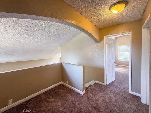 16702 Canoe Cv, Moreno Valley, CA 92551 - corridor with a textured ceiling, carpet, arched walkways, an upstairs landing, and a textured wall