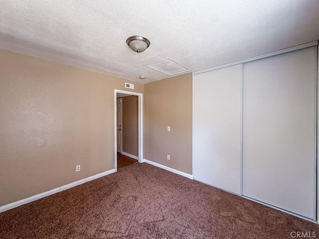 16702 Canoe Cv, Moreno Valley, CA 92551 - unfurnished bedroom with attic access, carpet floors, a closet, and a textured ceiling