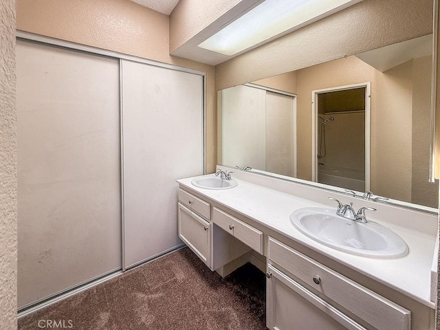 16702 Canoe Cv, Moreno Valley, CA 92551 - full bathroom with double vanity, a textured wall, and a shower