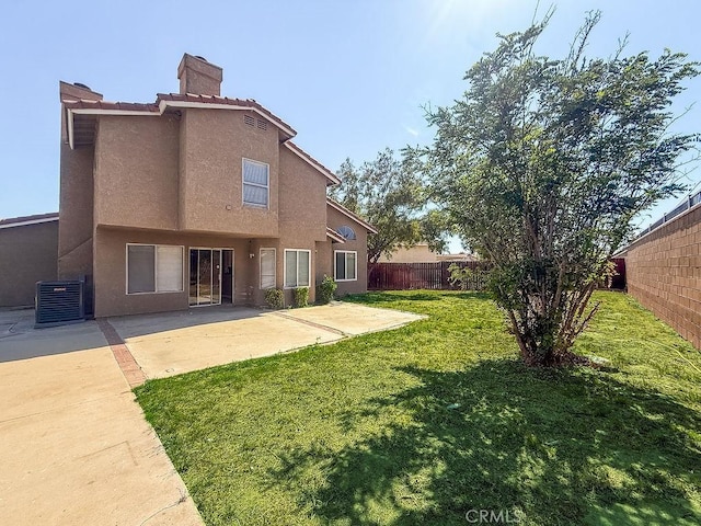 16702 Canoe Cv, Moreno Valley, CA 92551 - back of house with stucco siding, a chimney, a fenced backyard, and a patio