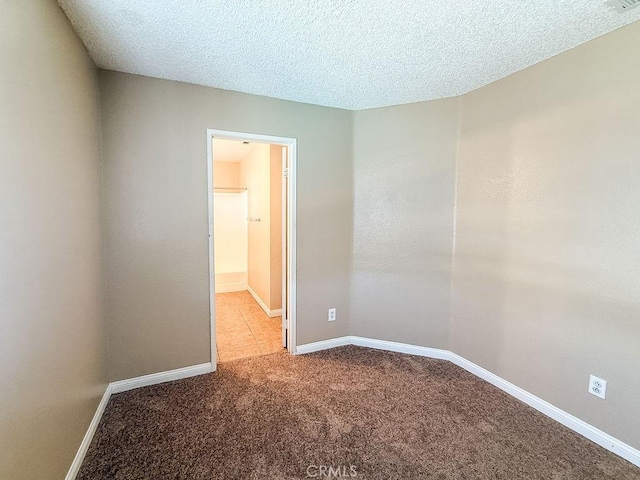 16702 Canoe Cv, Moreno Valley, CA 92551 - carpeted empty room with baseboards and a textured ceiling
