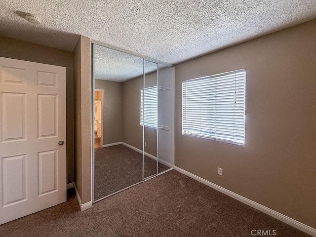 16702 Canoe Cv, Moreno Valley, CA 92551 - unfurnished bedroom featuring dark colored carpet, a textured ceiling, and a closet