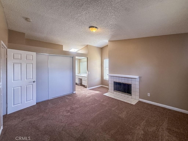 16702 Canoe Cv, Moreno Valley, CA 92551 - unfurnished living room featuring carpet, a tile fireplace, and a textured ceiling