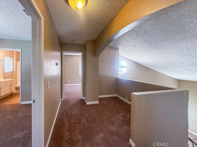 16702 Canoe Cv, Moreno Valley, CA 92551 - corridor featuring a textured ceiling, arched walkways, and carpet