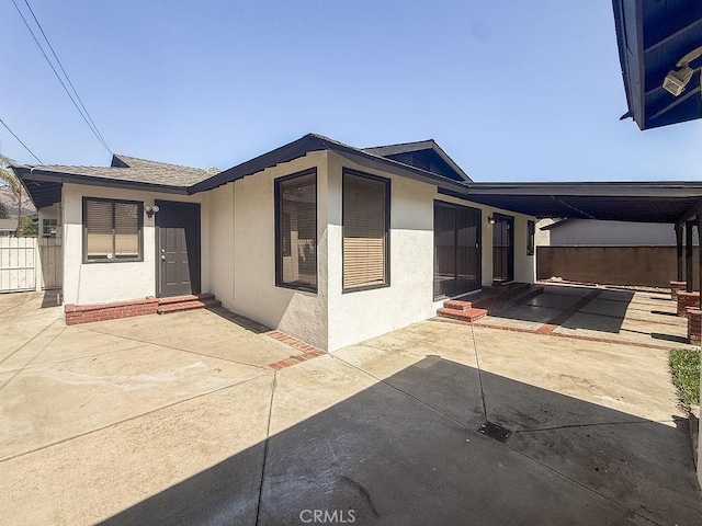 409 N Elwood Ave, Glendora, CA 91741 - rear view of house featuring stucco siding, entry steps, and a patio