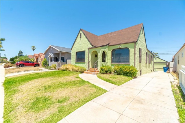 2027 W 70th St, Los Angeles, CA 90047 - tudor house featuring stucco siding and a front lawn
