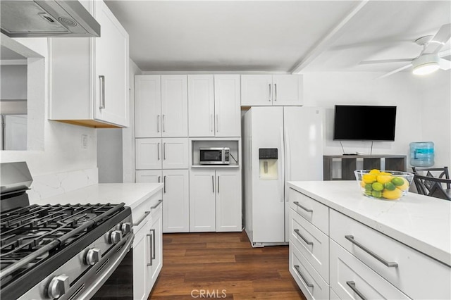 2027 W 70th St, Los Angeles, CA 90047 - kitchen featuring appliances with stainless steel finishes, under cabinet range hood, white cabinetry, and dark wood finished floors