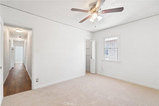 2027 W 70th St, Los Angeles, CA 90047 - carpeted empty room with baseboards and a ceiling fan