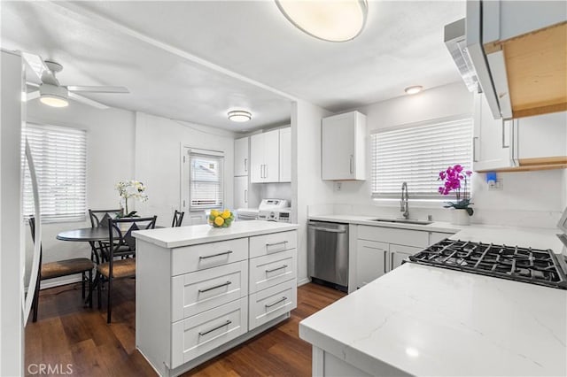2027 W 70th St, Los Angeles, CA 90047 - kitchen with stainless steel dishwasher, washing machine and dryer, a kitchen island, and plenty of natural light