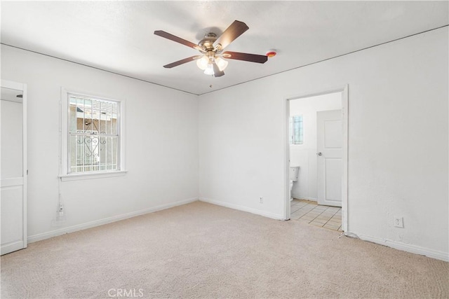 2027 W 70th St, Los Angeles, CA 90047 - unfurnished bedroom featuring carpet floors, ensuite bathroom, and a ceiling fan