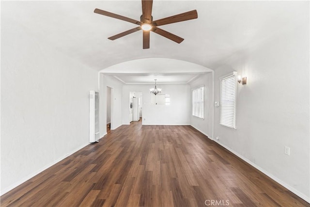 2027 W 70th St, Los Angeles, CA 90047 - unfurnished living room with a heating unit, a chandelier, arched walkways, ceiling fan, and dark wood-type flooring