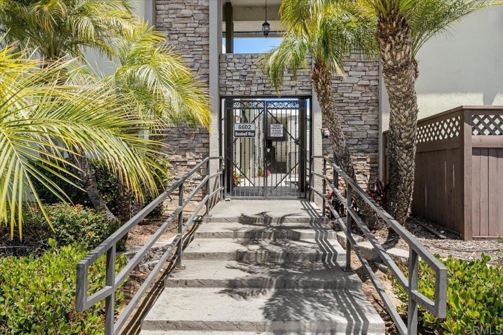 6602 Beadnell Way Unit 10, San Diego, CA 92117 - entrance to property featuring a gate and stone siding