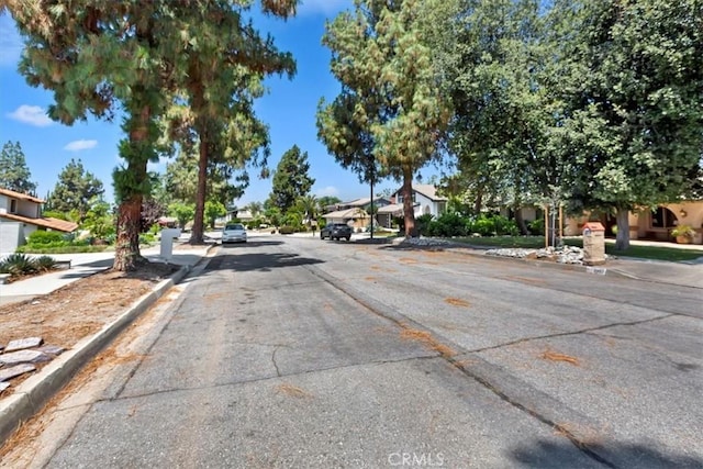2287 Kemper Ave, Claremont, CA 91711 - view of asphalt road featuring curbs, sidewalks, and a residential view